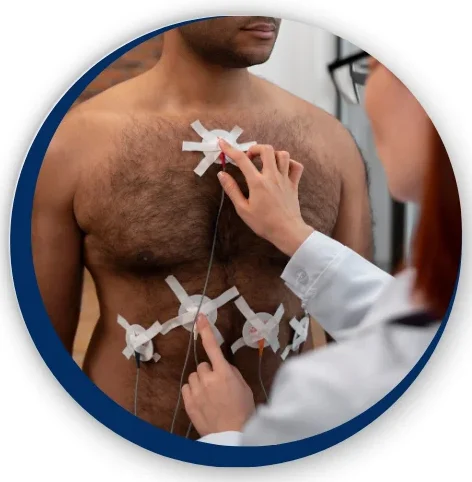 Doctor applying ECG electrodes to a patient’s chest for Holter Monitoring in Bhopal, ensuring proper placement for accurate heart rhythm recording.