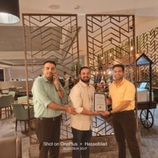 Dr. Swapnil Garde proudly accepts an award from peers in a formal setting, reflecting his achievements and recognition as the best cardiologist in Bhopal.